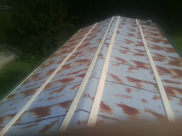 Rusted metal roof panels with new wood purlins before replacement — Storm Damage Roof Repair in Wagram by Roofing Brothers
